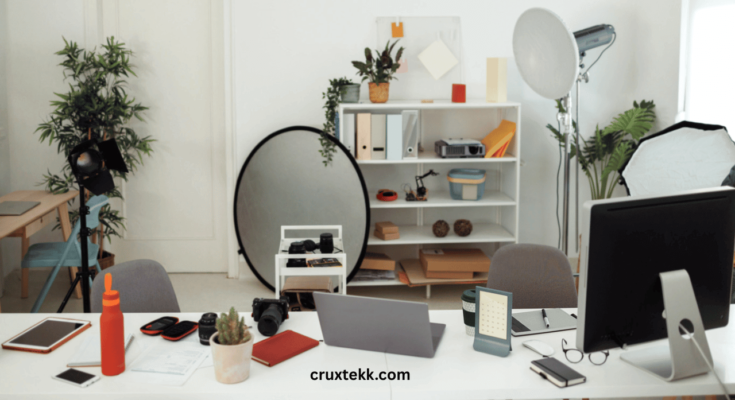 A modern home office setup with a smart standing desk, noise-canceling headphones, and an AI-powered assistant.